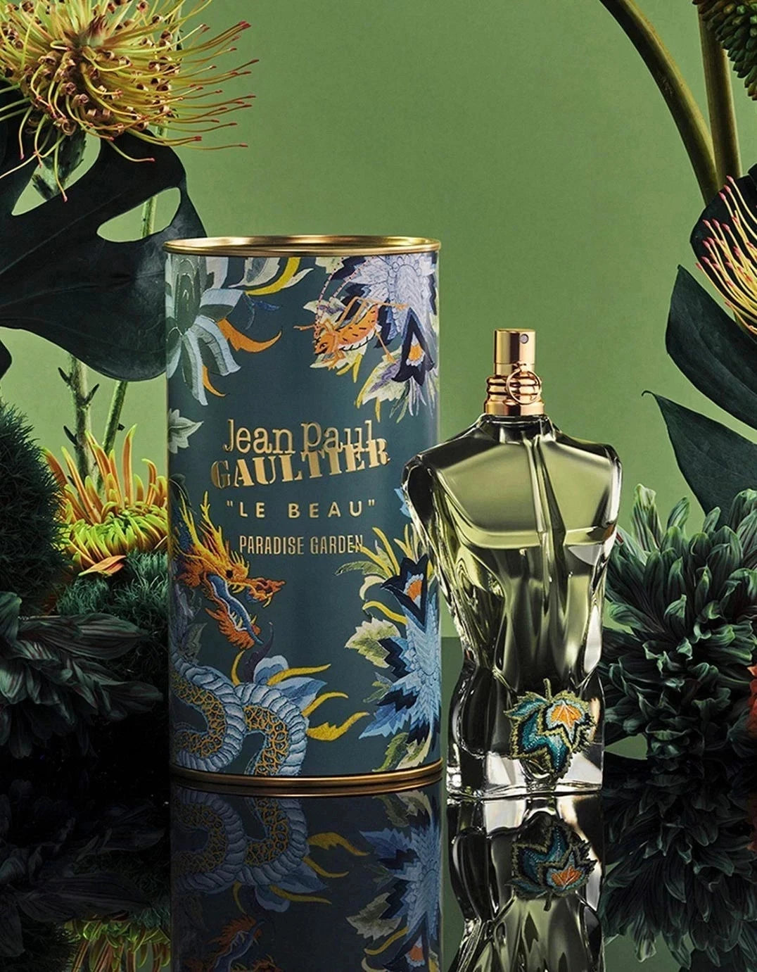 Jean Paul Gaultier perfume bottle and packaging with floral design on a green background